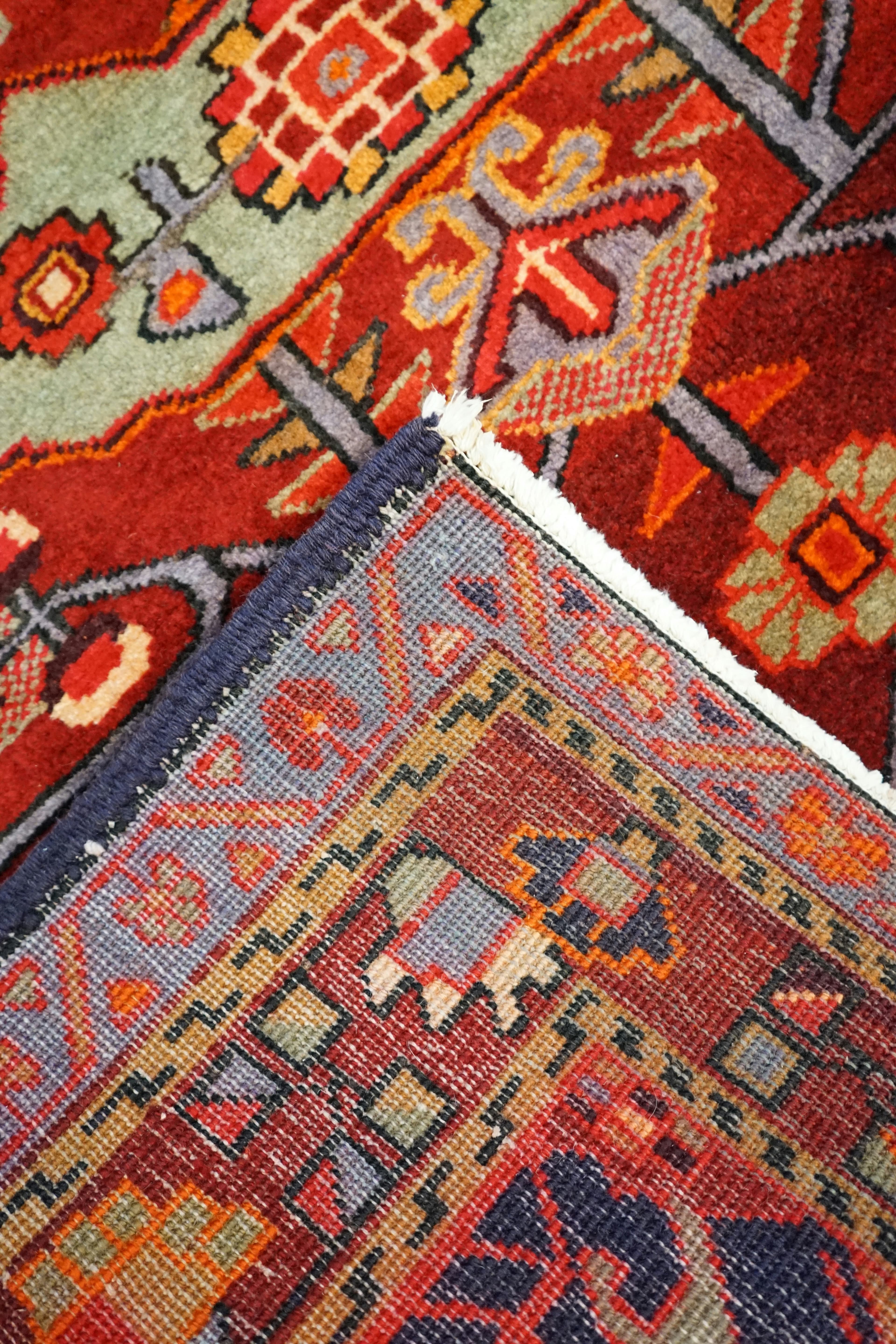 Front and back of a hand-knotted oriental rug compared side by side